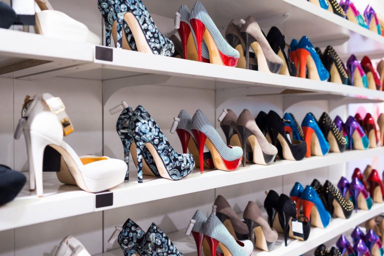Rows of platform shoes on shoe shelf
