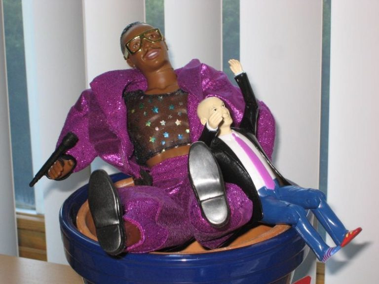 Plastic MC Hammer Figure wearing purple jacket and trousers with seth godin