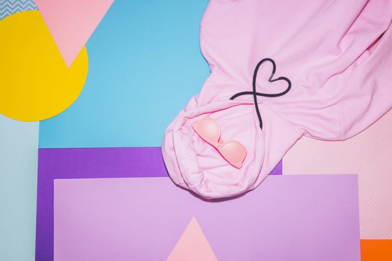 a pink 90s style sweatshirt with drawstrings in the shape of a heart