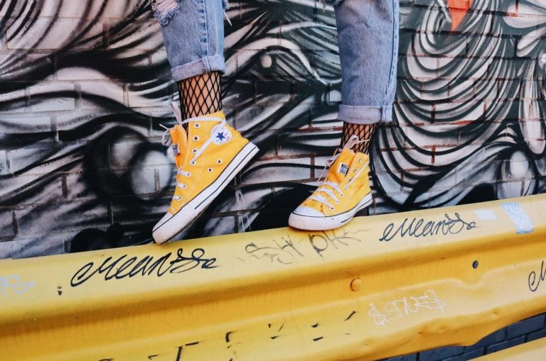 Woman wearing yellow hi top converse